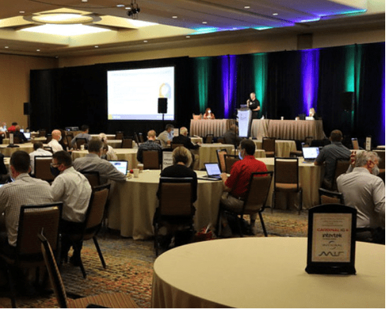 attendees listening to a speaker